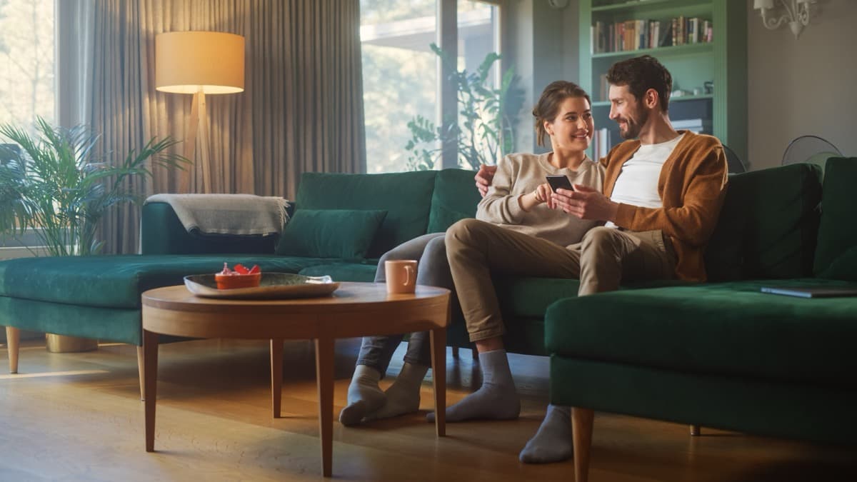 Couple communicating together on couch